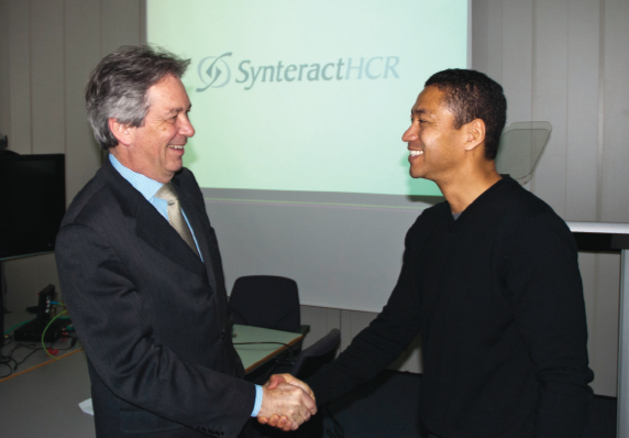 Photo courtesy of SynteractHCR
Dr. Francisco Harrison, left, founder of Harrison Clinical Research, shakes hands with Wendel Barr, CEO of SynteractHCR. Synteract’s acquisition of Munich, Germany-based Harrison Clinical Research Group GmbH gives it a much bigger global presence.